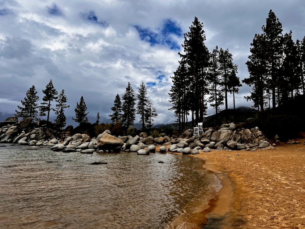 a sandy beach next to a body of water