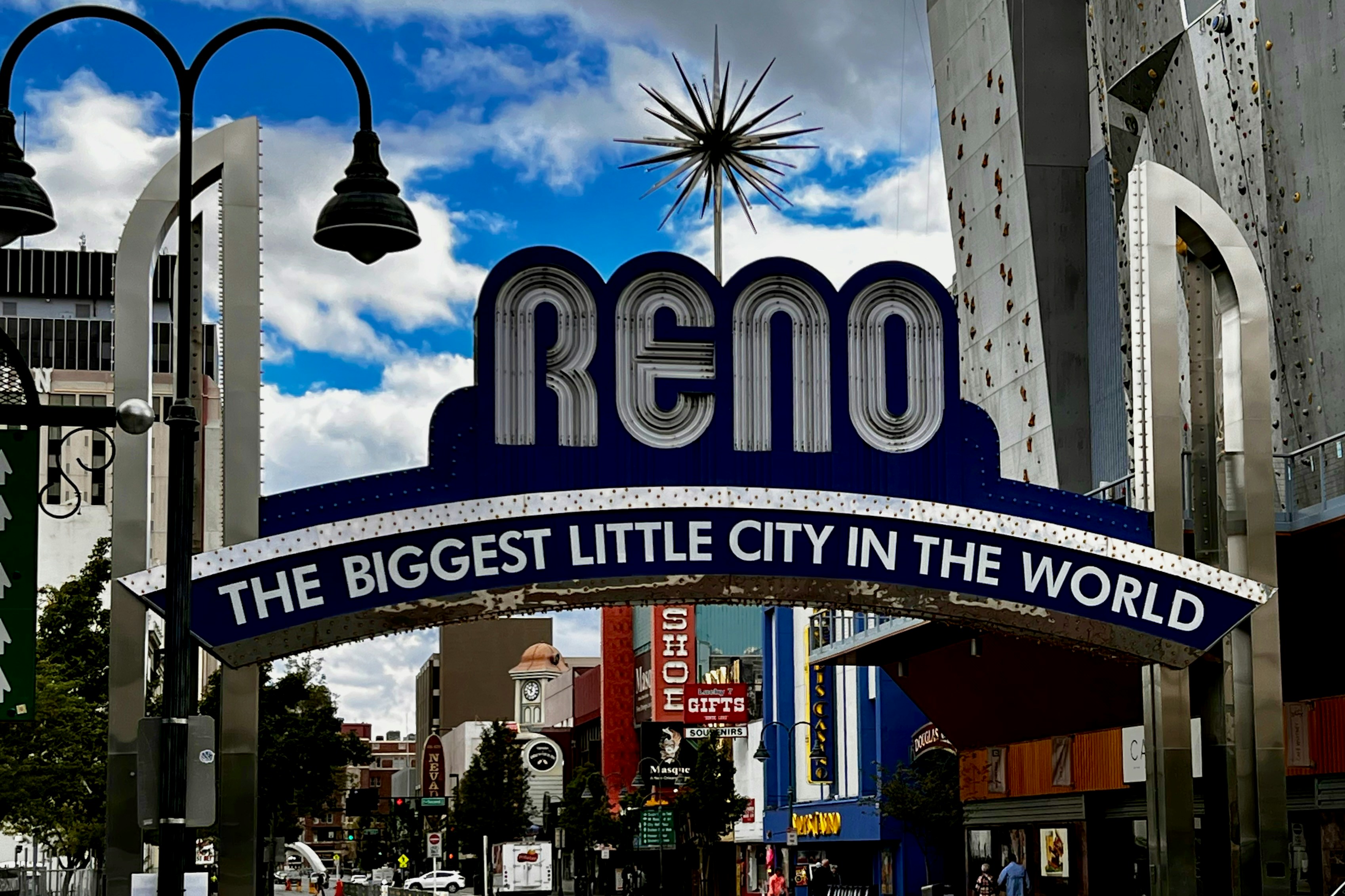 a city street with a sign that says reno the biggest little city in the world, 