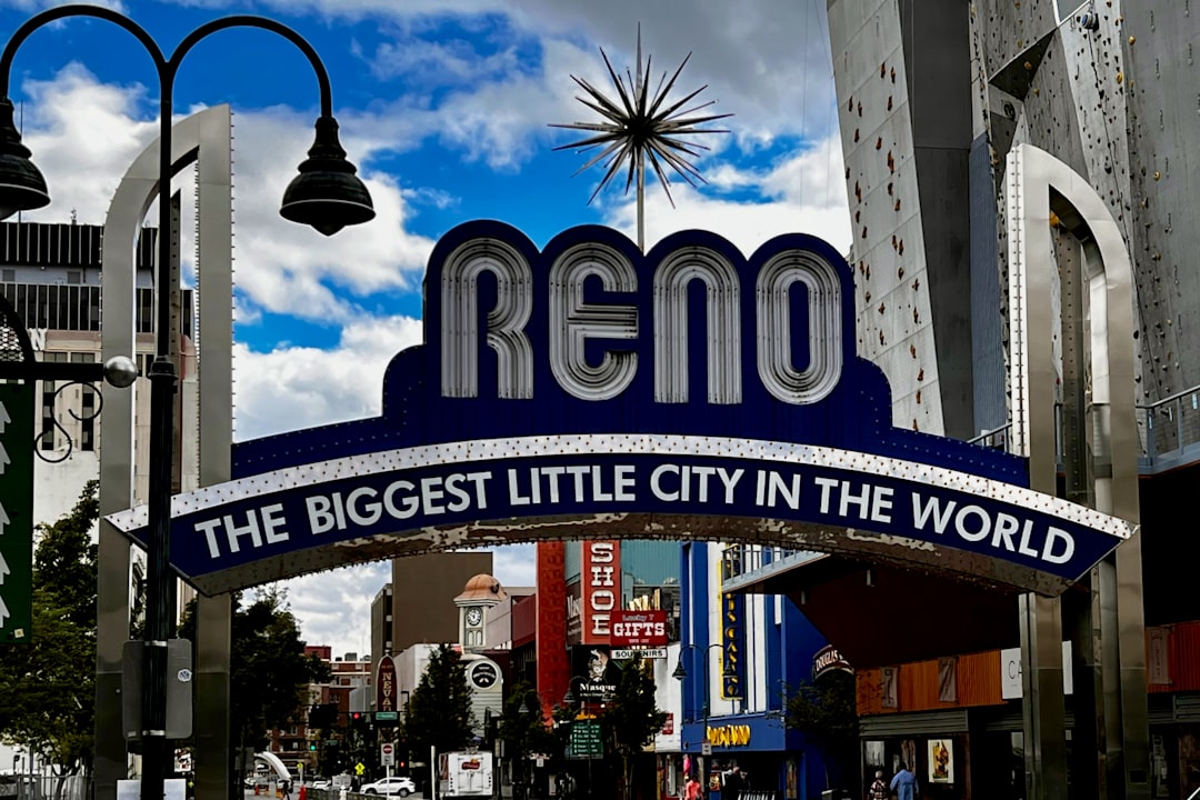 a city street with a sign that says reno the biggest little city in the world,