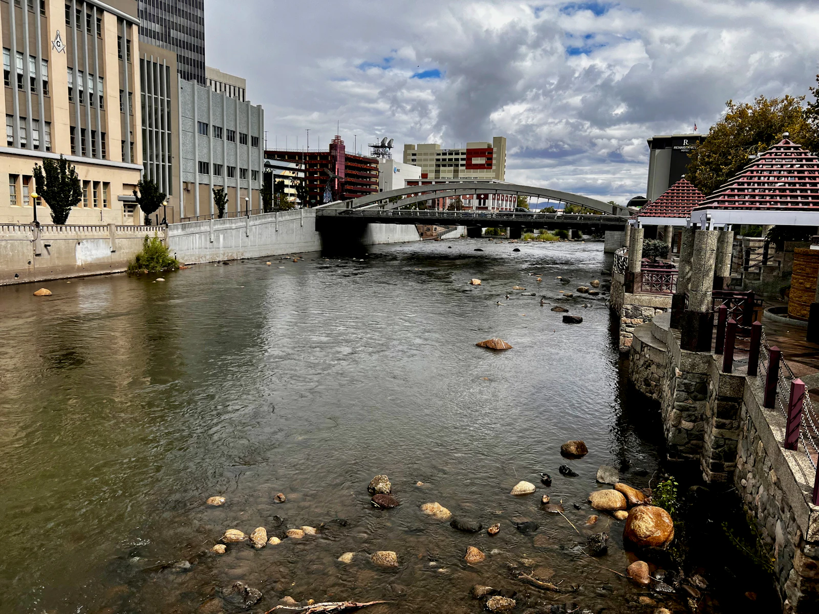 A river running through a downtown of low towers.