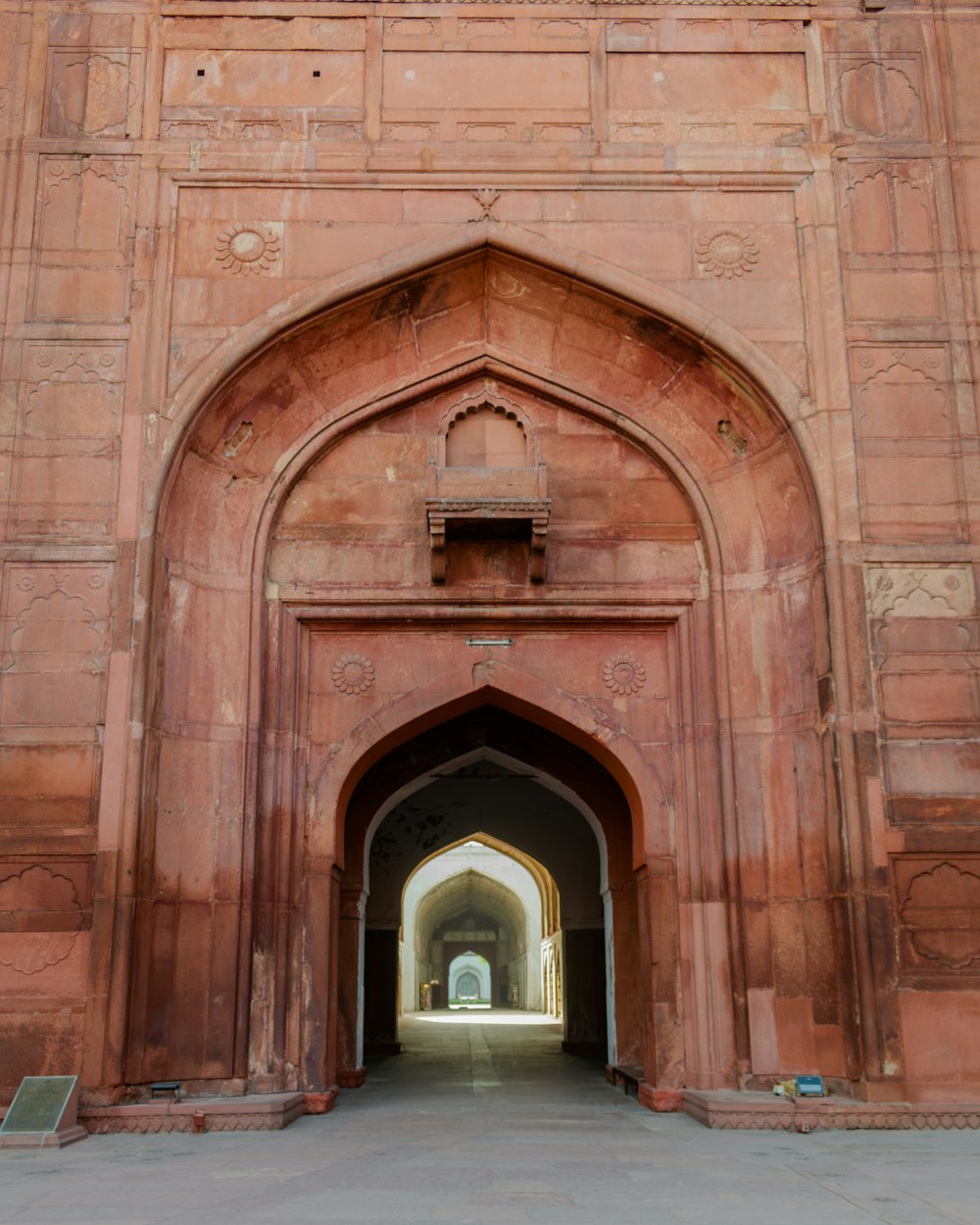 a large archway with a clock on the side of it