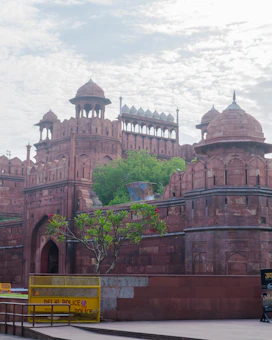 A vibrant collage showing Delhi's India Gate, Agra's Taj Mahal at sunset, and Jaipur's Amber Fort.