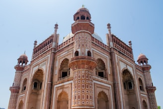 Historic Mughal palace with intricate stone carvings and arches.