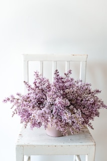 Sunlit corner with a minimalist chair and a blooming marais-inspired bouquet, reflecting graceful simplicity