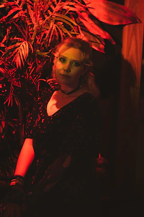 Behind-the-scenes shot of a photoshoot with deep crimson and forest green accents reflecting the agency’s color palette.