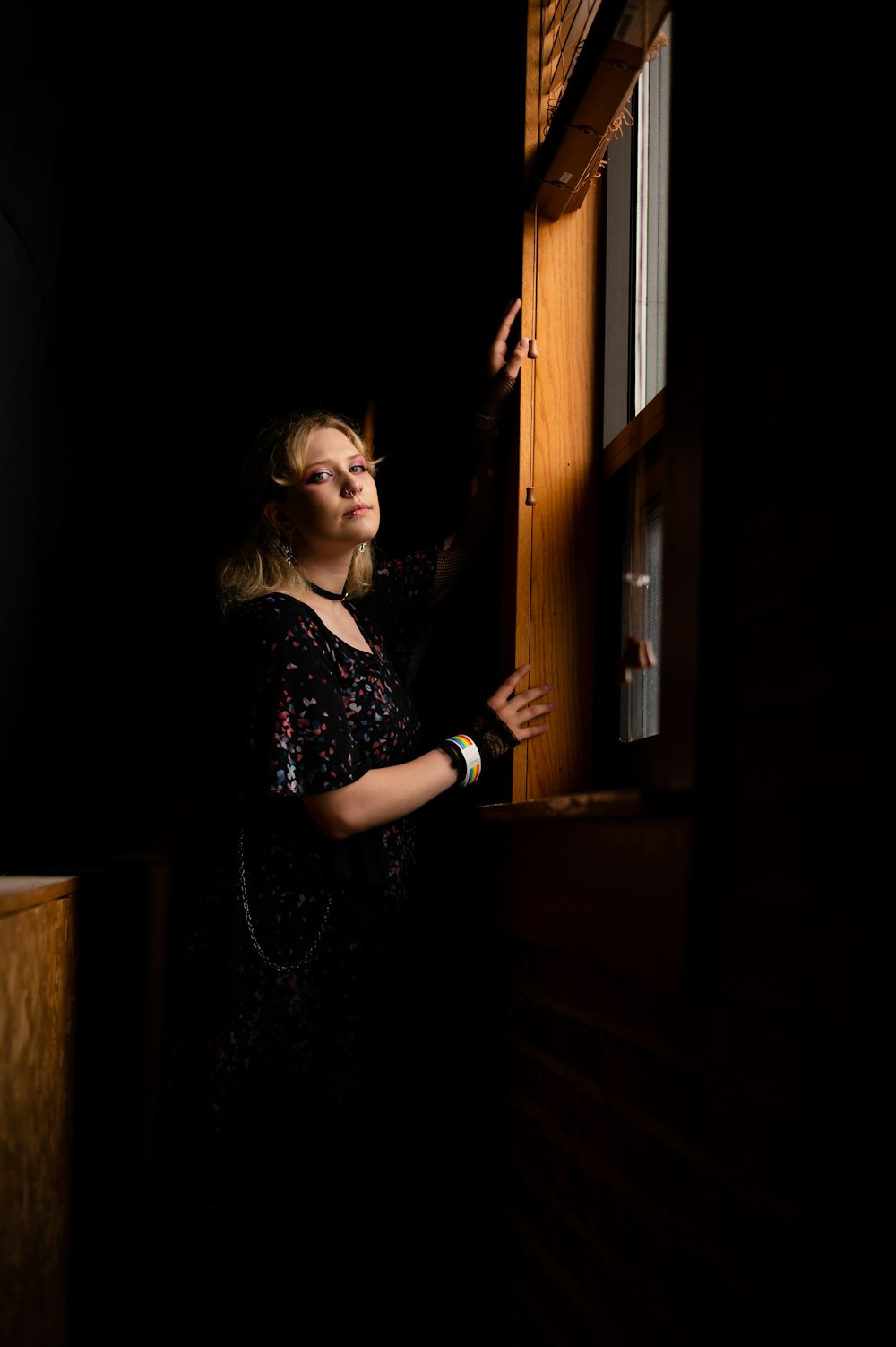 a woman looking out of a window in the dark
