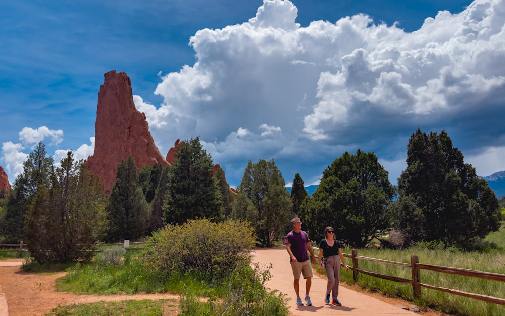 a couple of people that are walking down a path