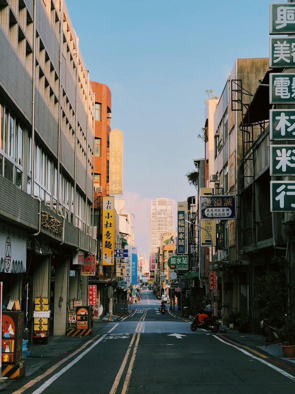 a narrow city street lined with tall buildings