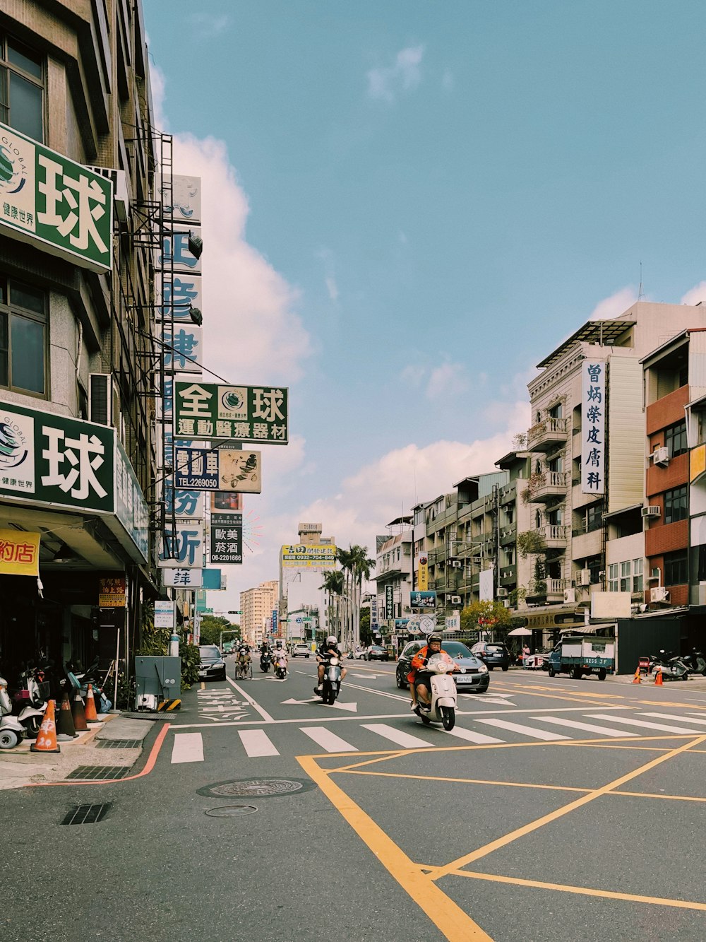 a city street filled with lots of tall buildings