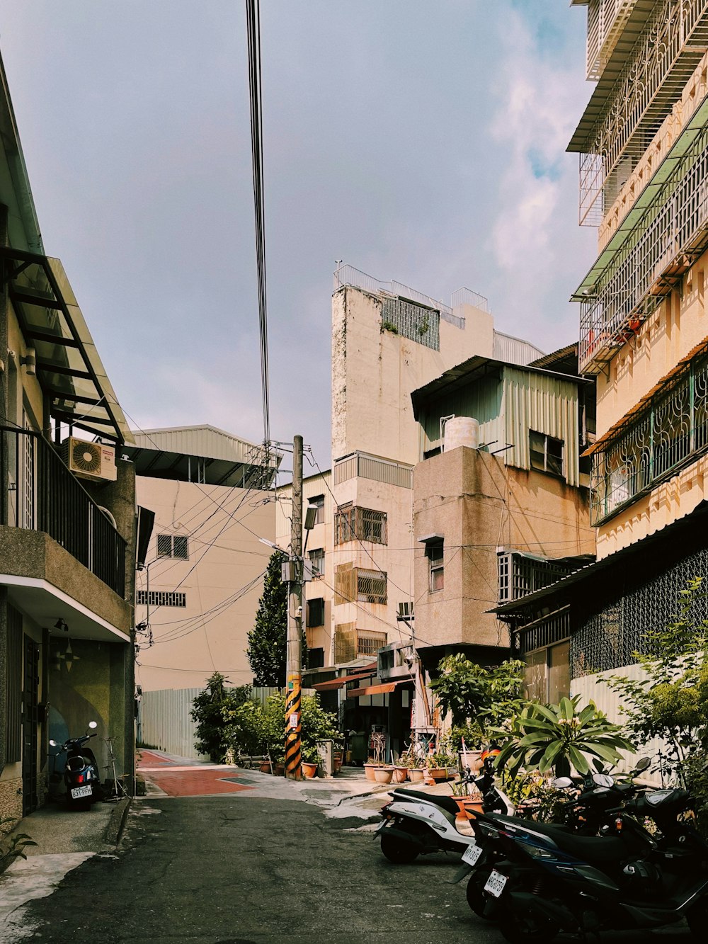 a city street with a bunch of motorcycles parked on the side of the road