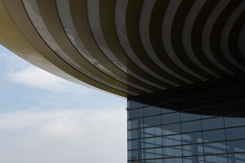 an airplane flying over a building with a sky background