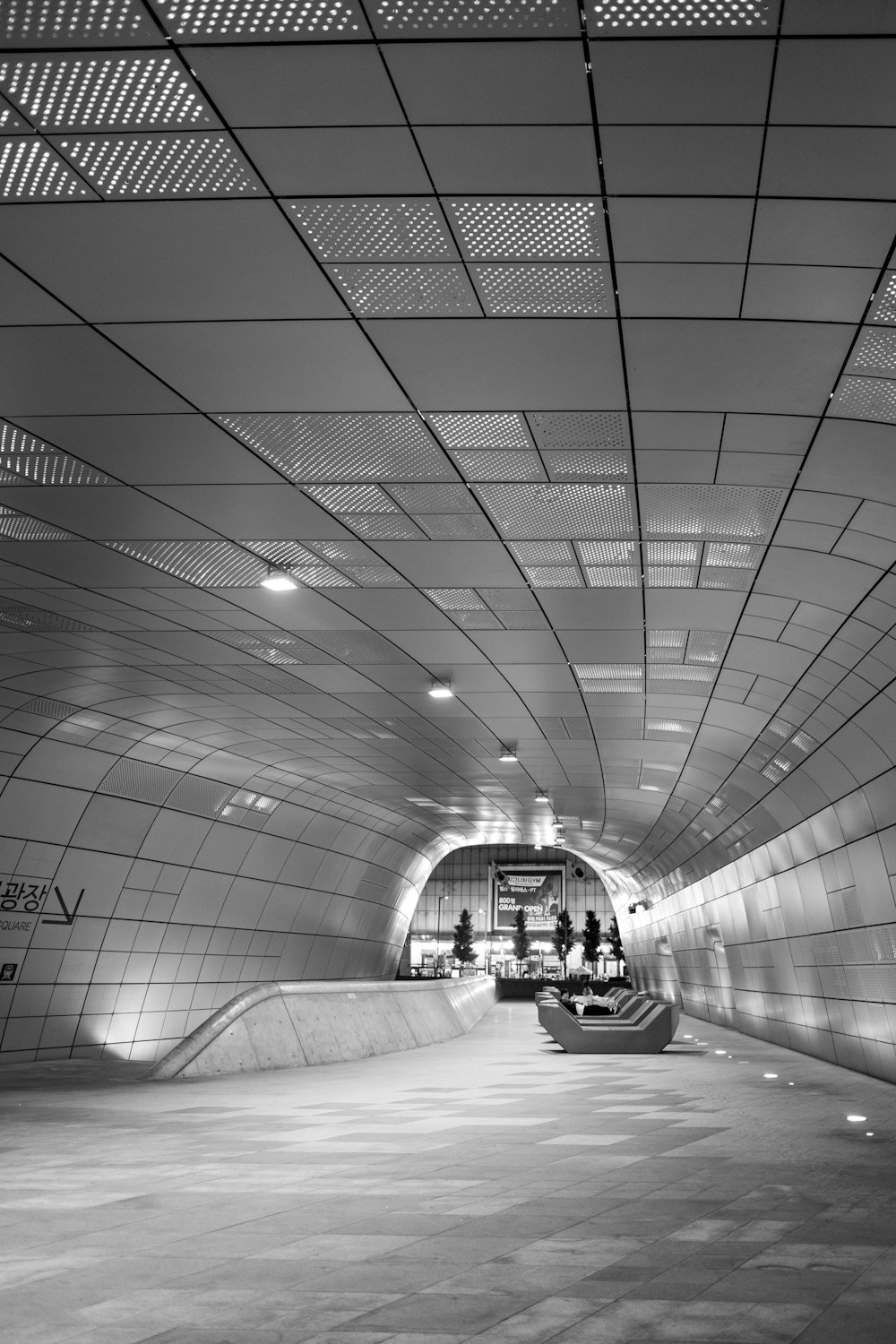 a black and white photo of a subway station