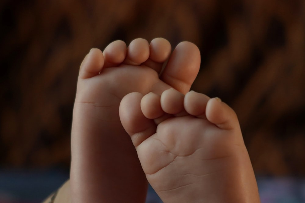 a close up of a baby's foot with a blurry background