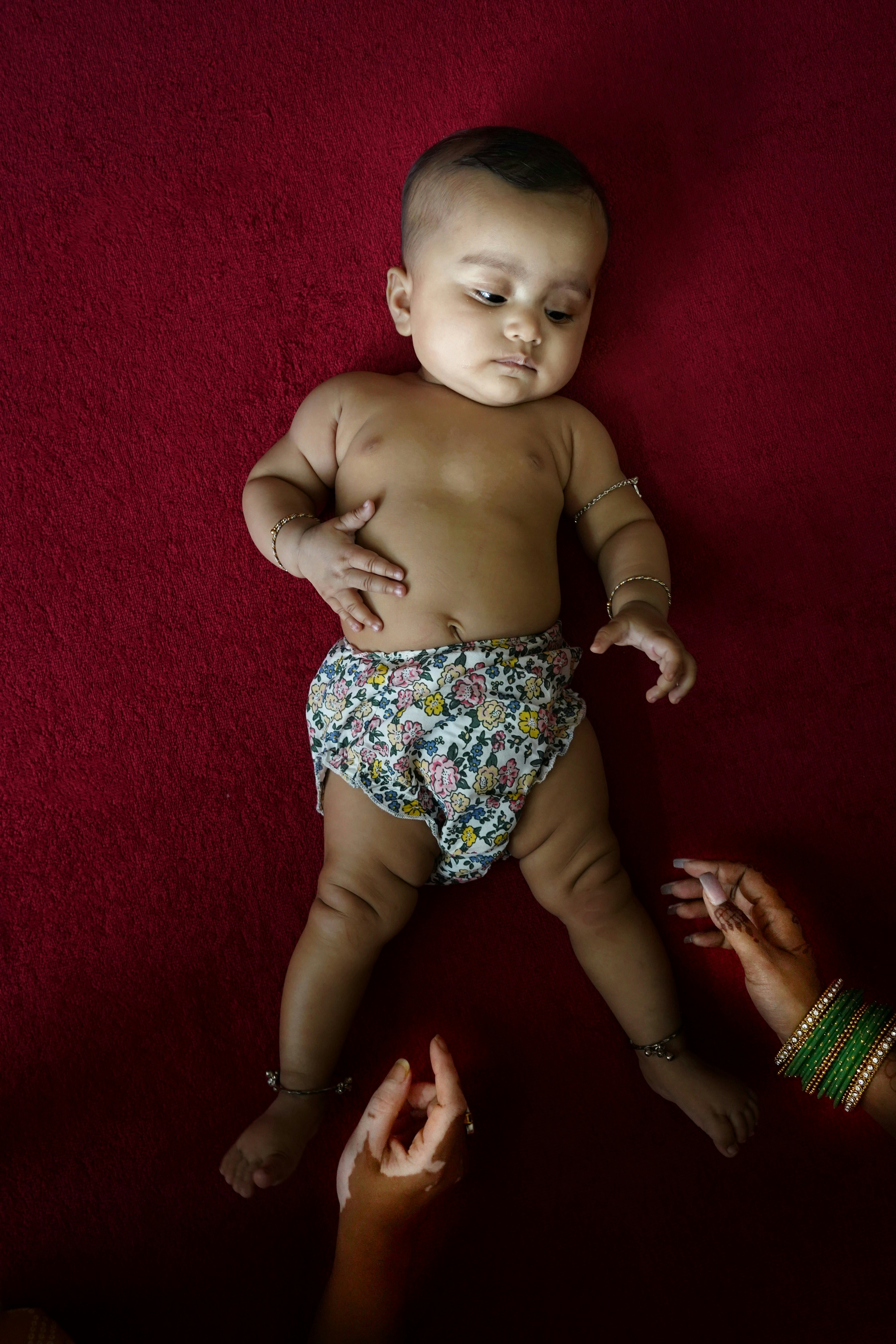 a baby in a diaper being held by a woman