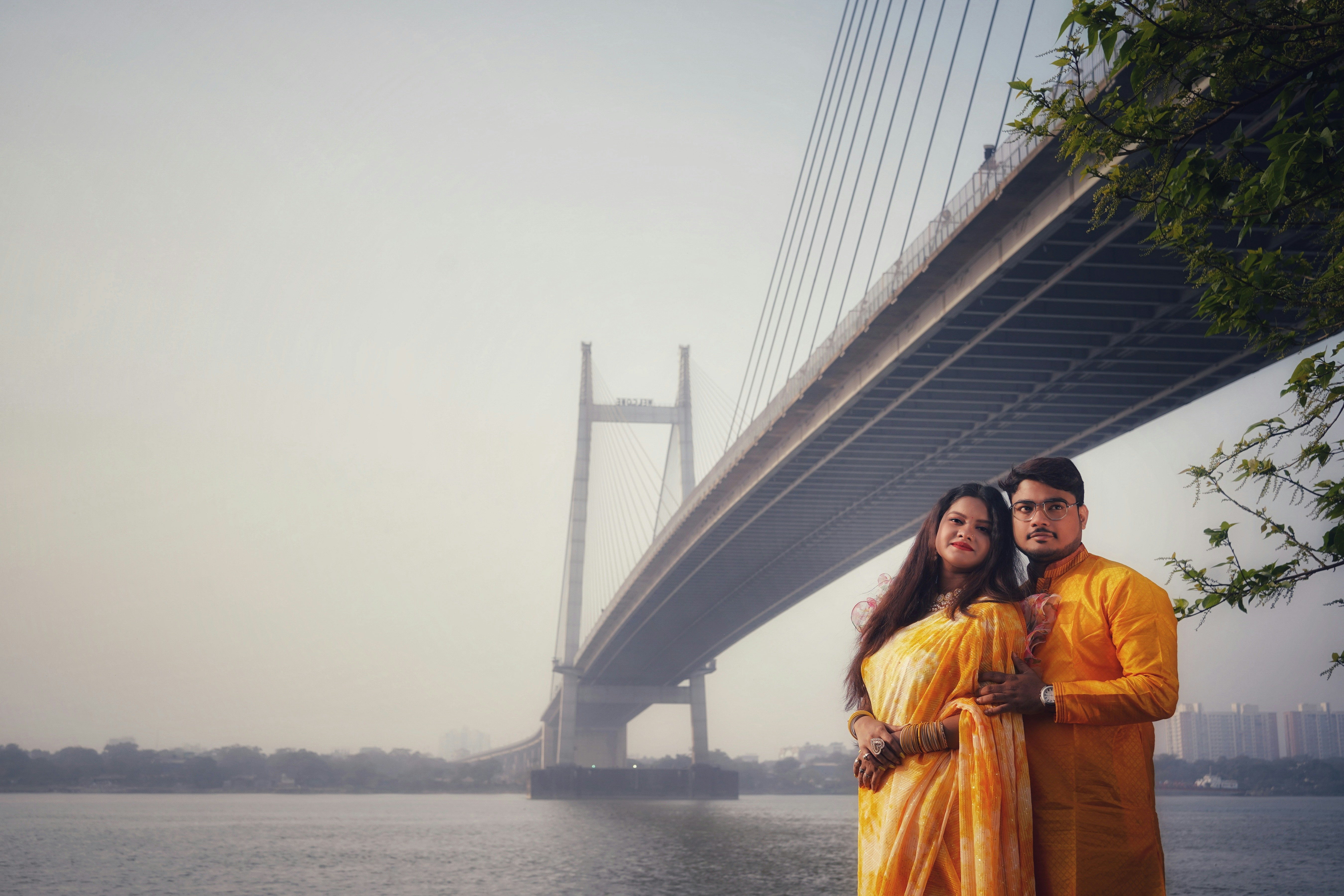 man and woman standing in front of bridge