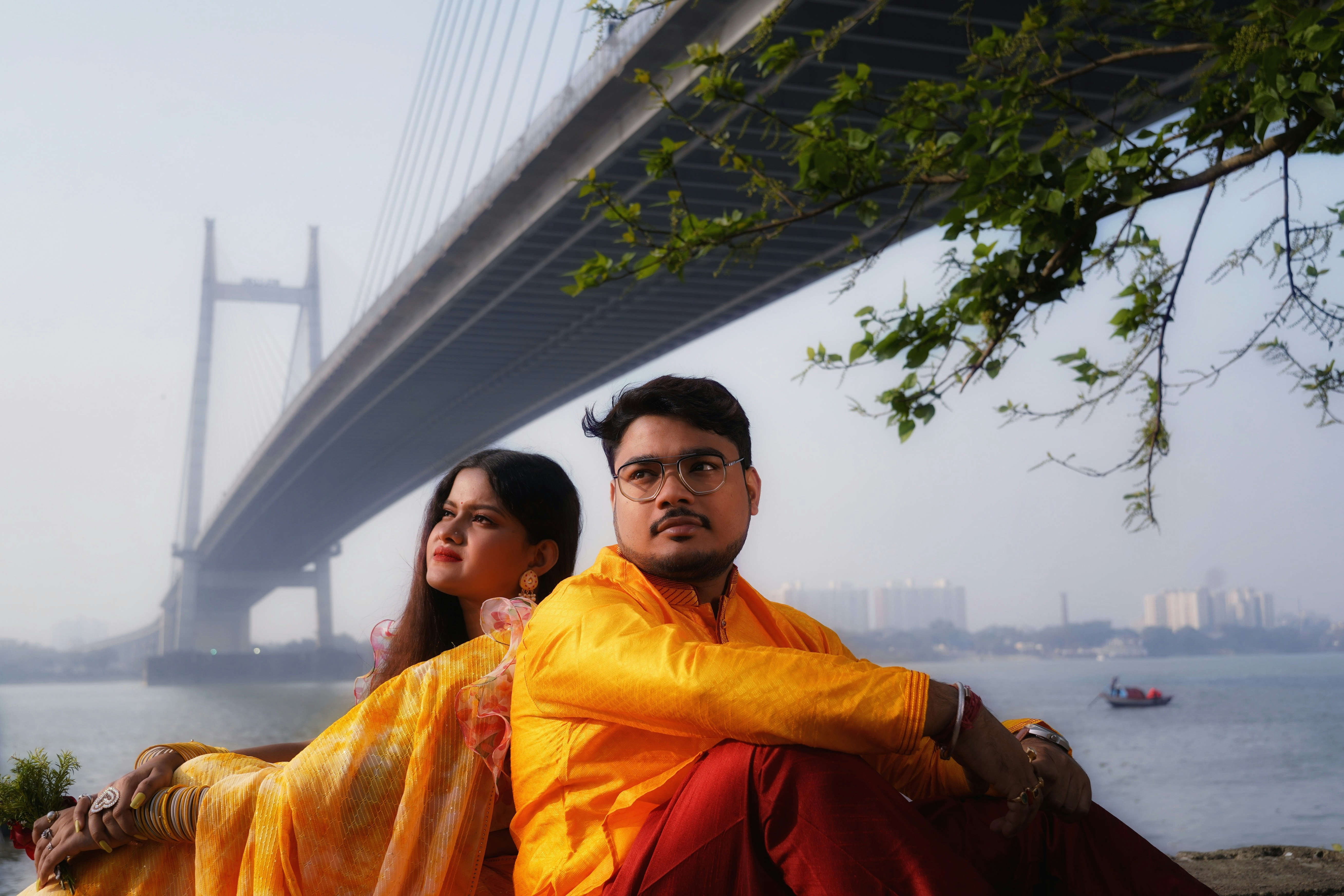 Indian couple in matching hoodies sitting at urban location