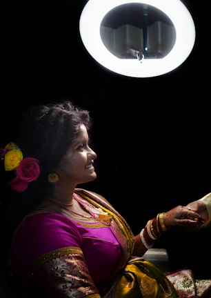 Close-up of a plus-size woman wearing a gold-accented kurti, smiling warmly in natural light.