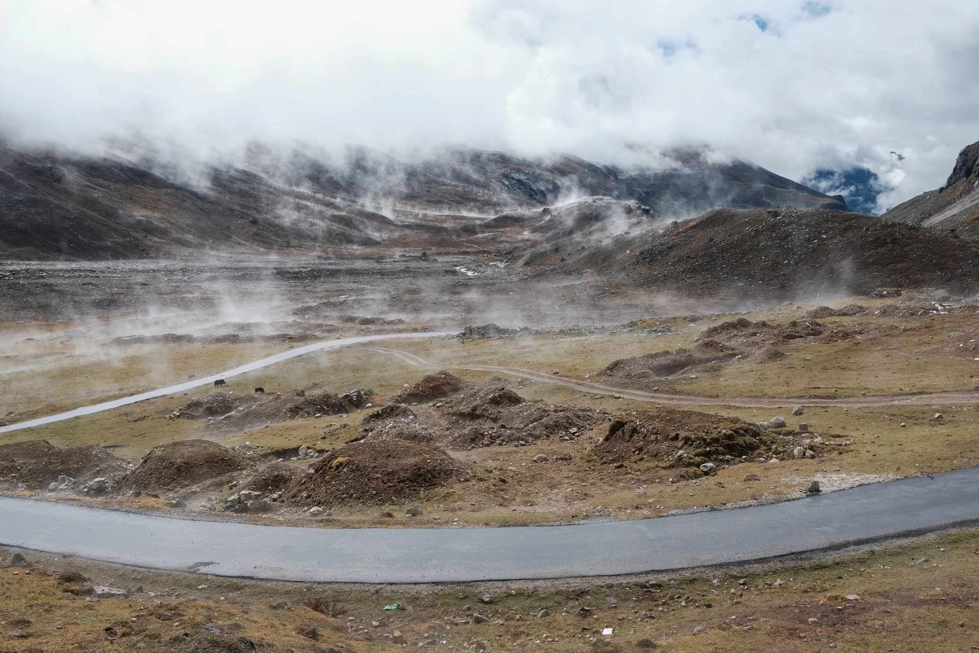 a winding road in the middle of a mountain range