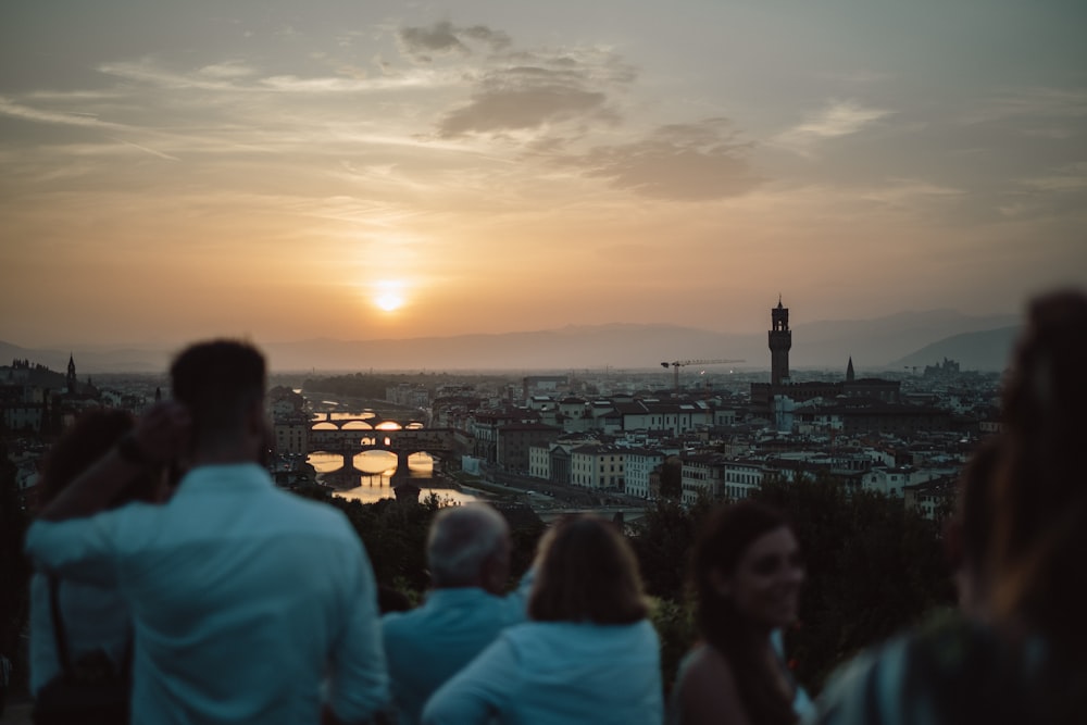 a group of people standing on top of a hill