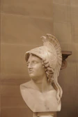 A bust of a mythical warrior, showcasing intricate armor and a determined expression.