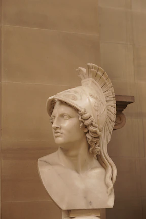 A bust of a mythical warrior, showcasing intricate armor and a determined expression.