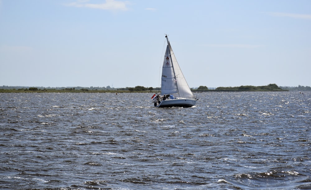 a sailboat sailing across a large body of water