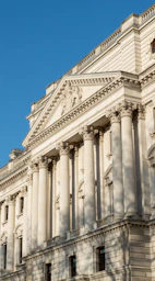 a large white building with a clock on it's side