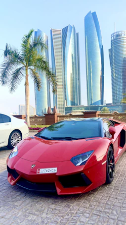 a red sports car parked in front of some tall buildings