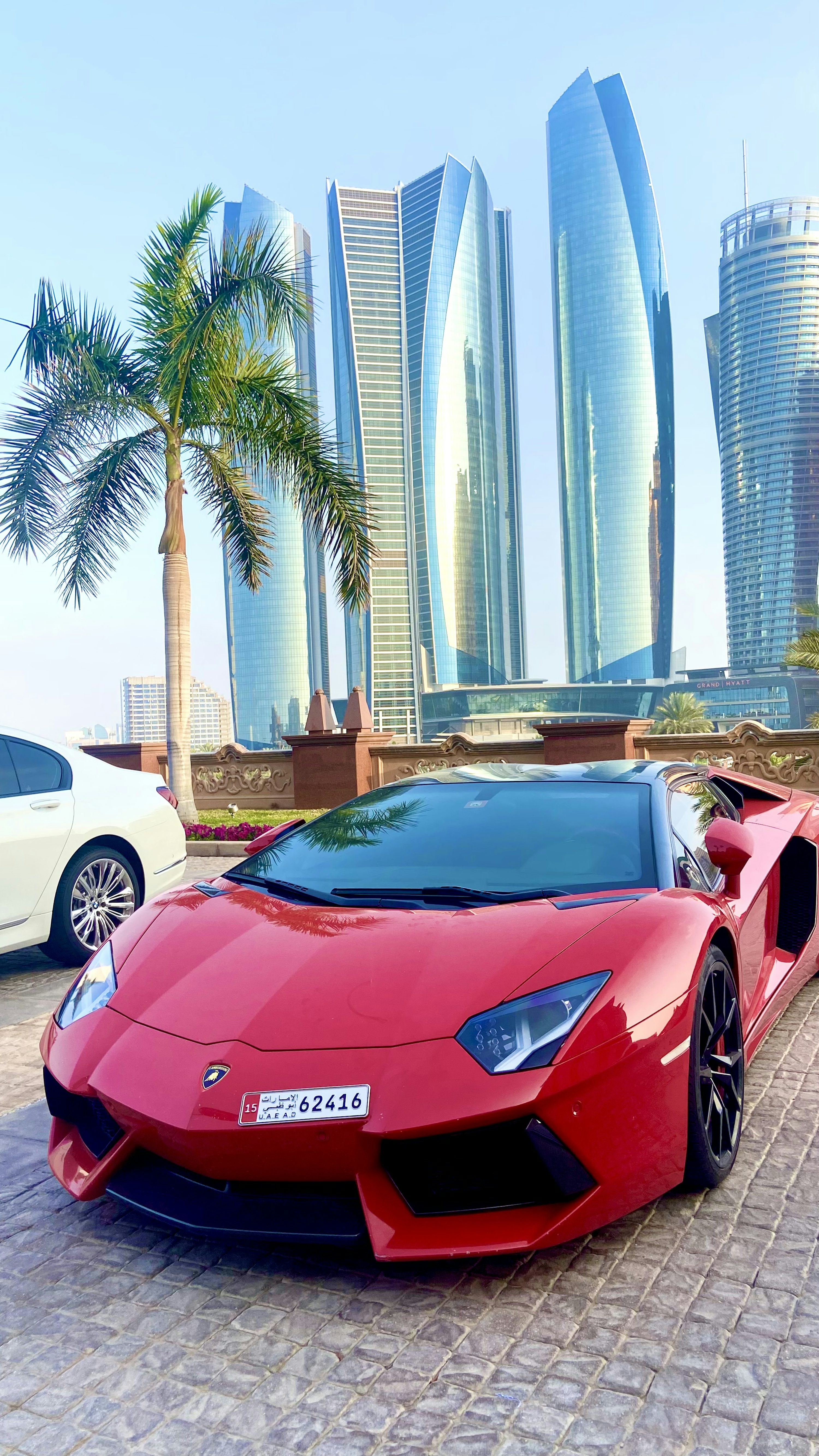 a red sports car parked in front of some tall buildings