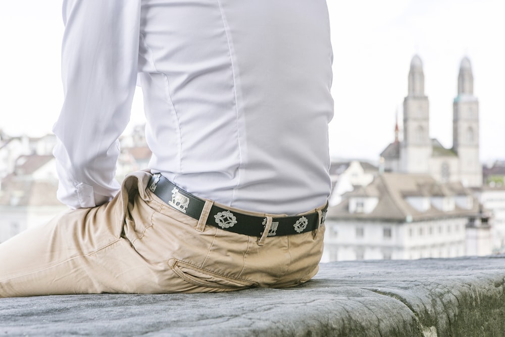 a man wearing a white shirt and tan pants