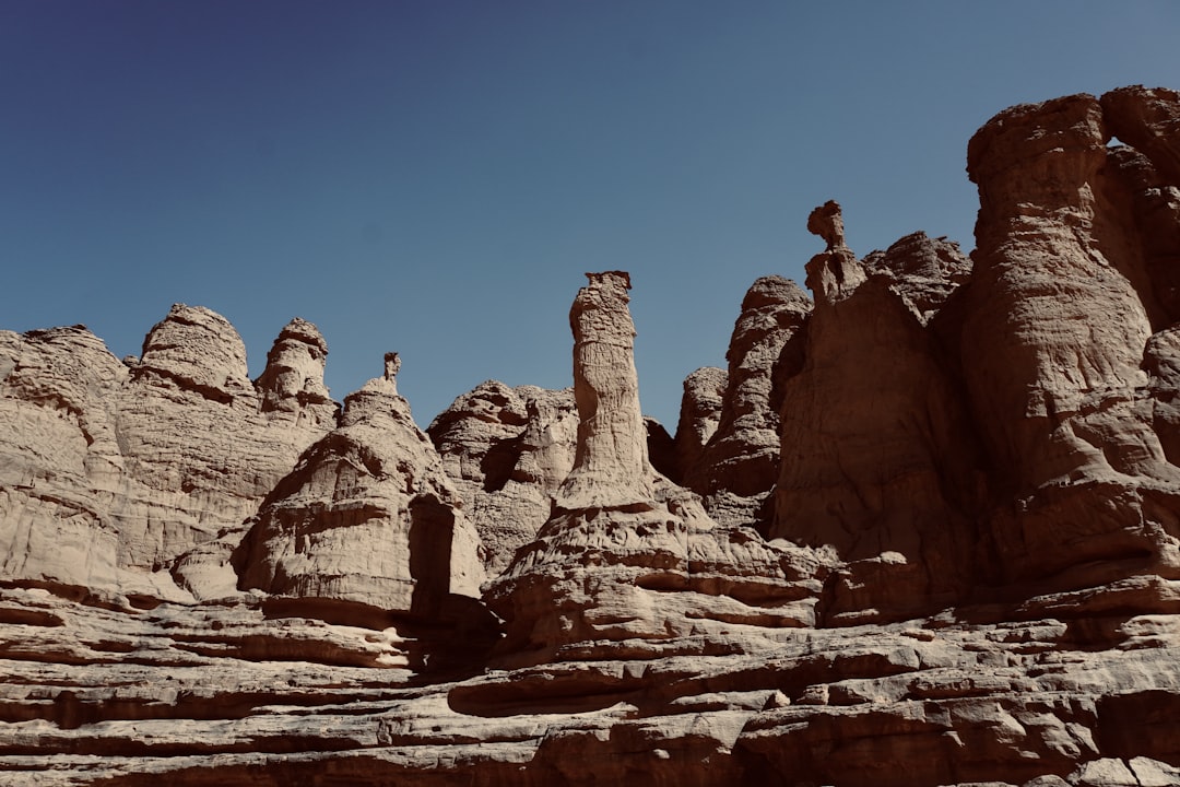 a large rock formation in the middle of a desert, On the way to Ahaggar National Park ( Algerian Sahara) photo made by r