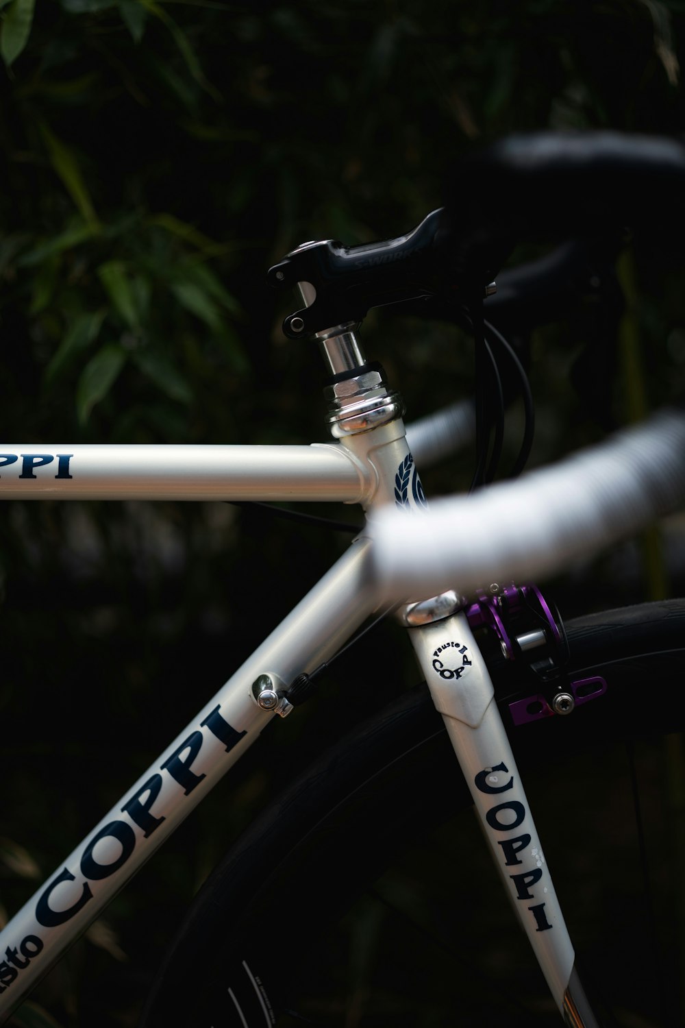 a close up of a white bicycle with blue lettering