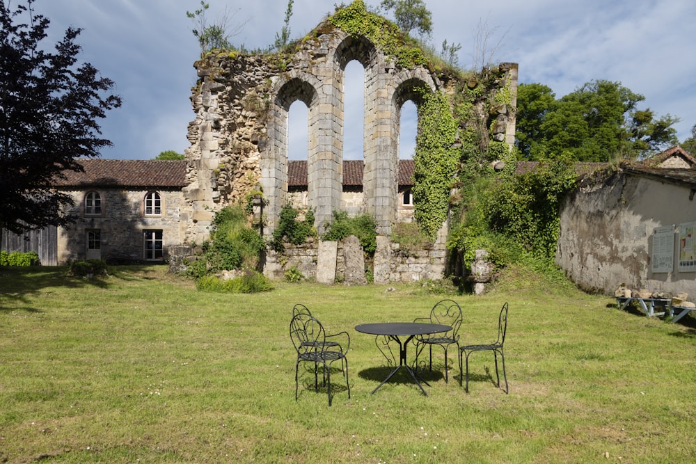 a table and chairs in front of an old building
