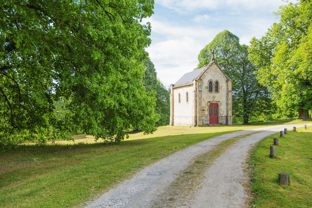 an old church sits in the middle of a field