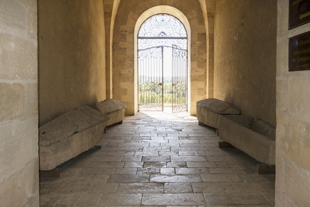 a hallway with two couches and a gate