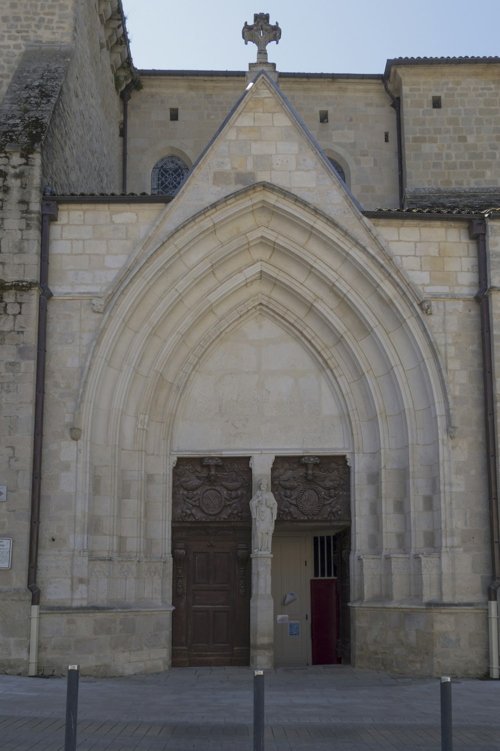 a large stone building with a cross on top of it