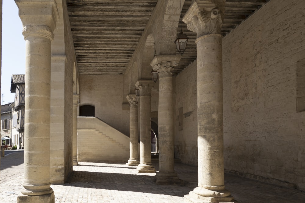 a row of stone pillars in an old building