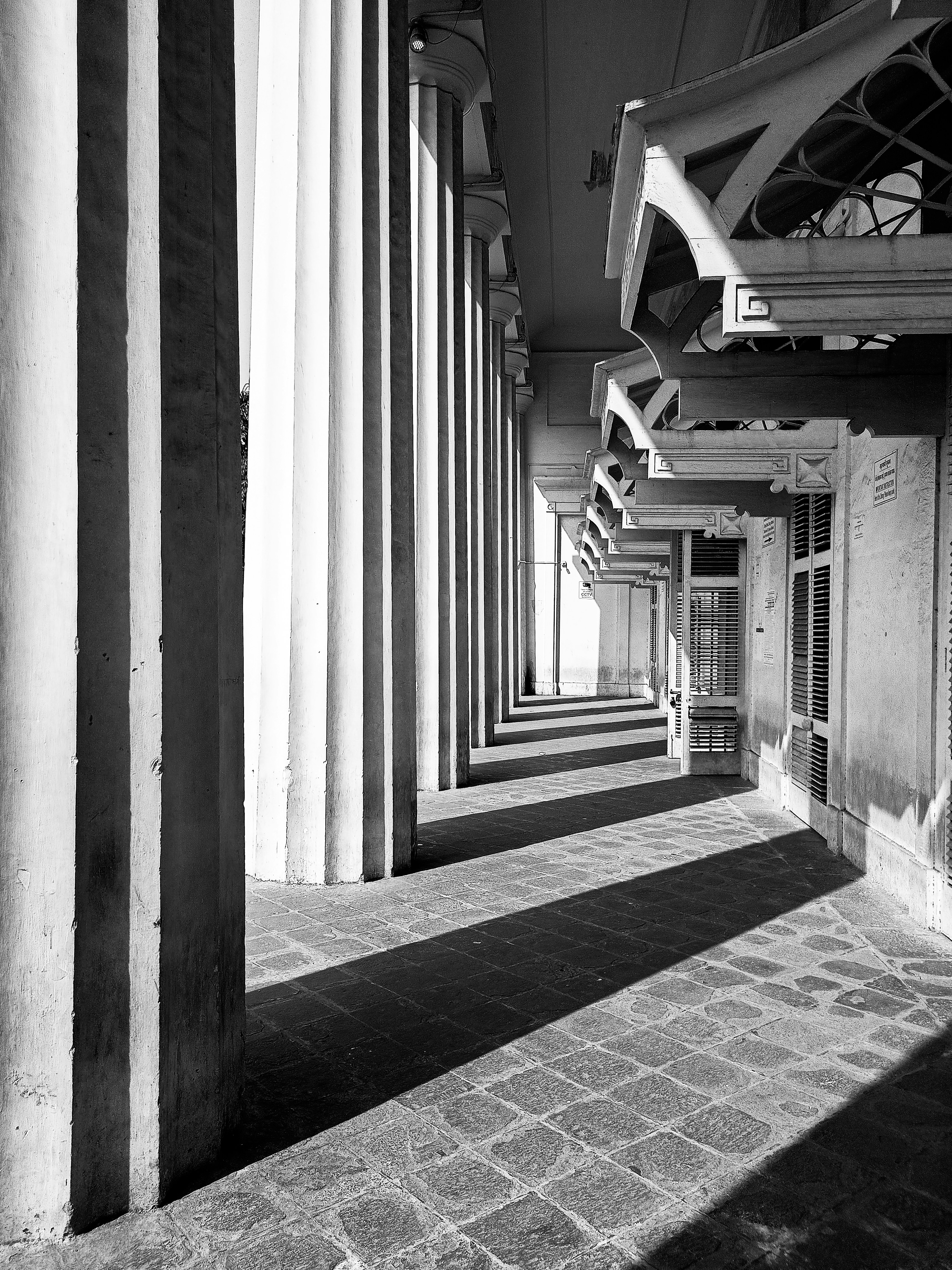 a black and white photo of a building with columns