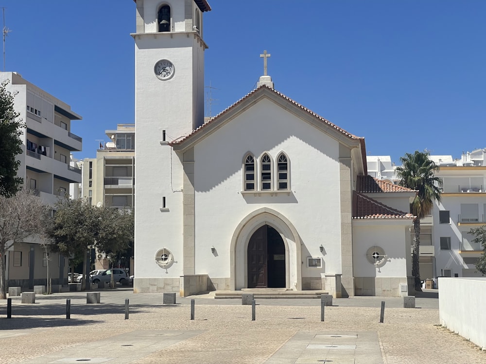 a white church with a clock on the tower