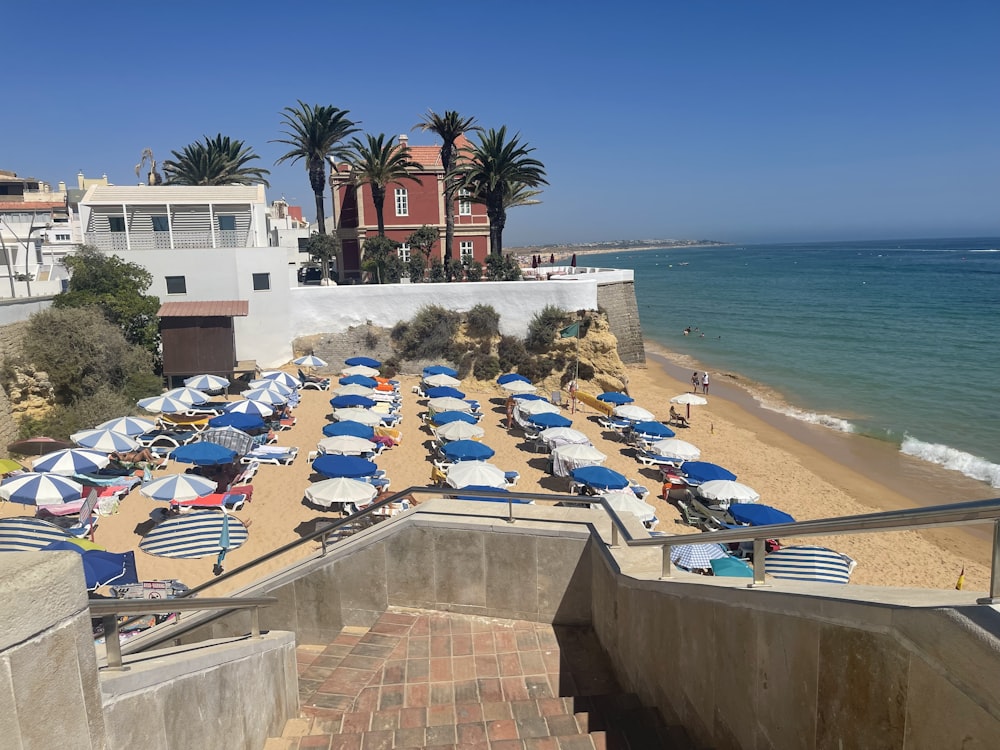 a bunch of umbrellas that are on a beach