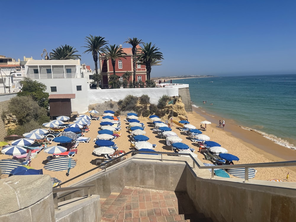 a bunch of umbrellas that are on a beach