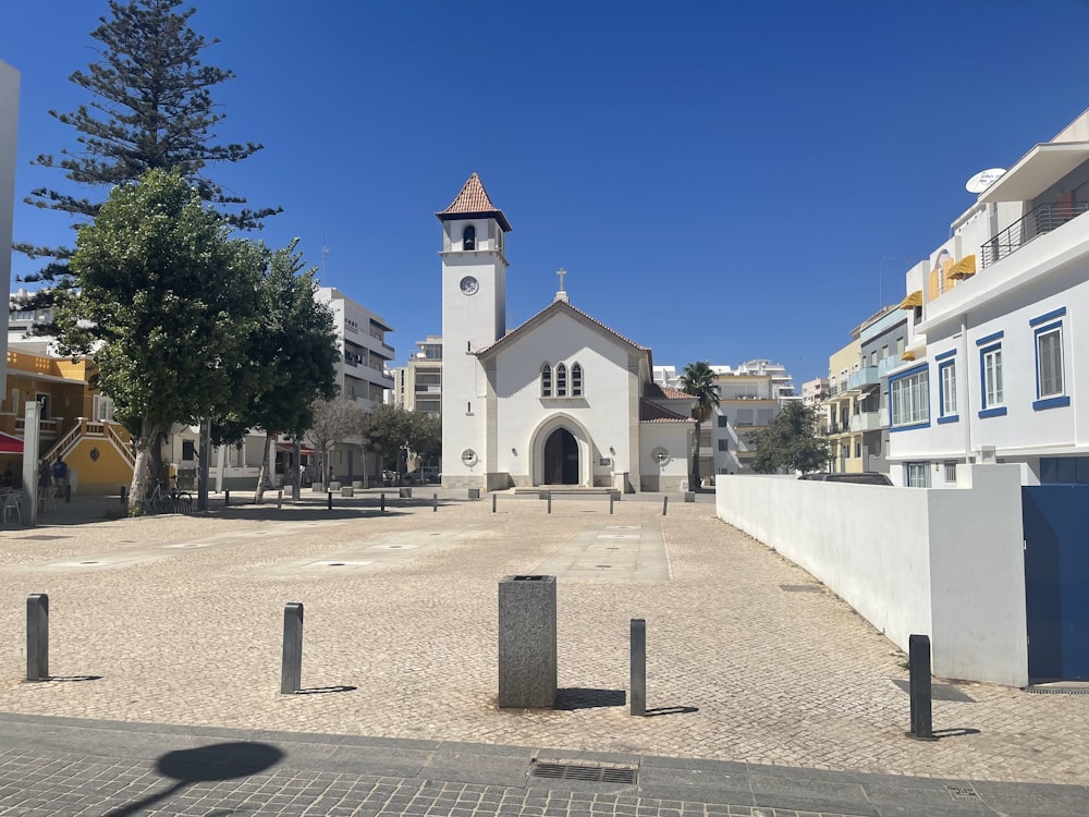 a small white church with a clock tower