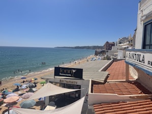 A sunny beach scene with families enjoying a meal at a seaside restaurant in Costa Blanca Norte.