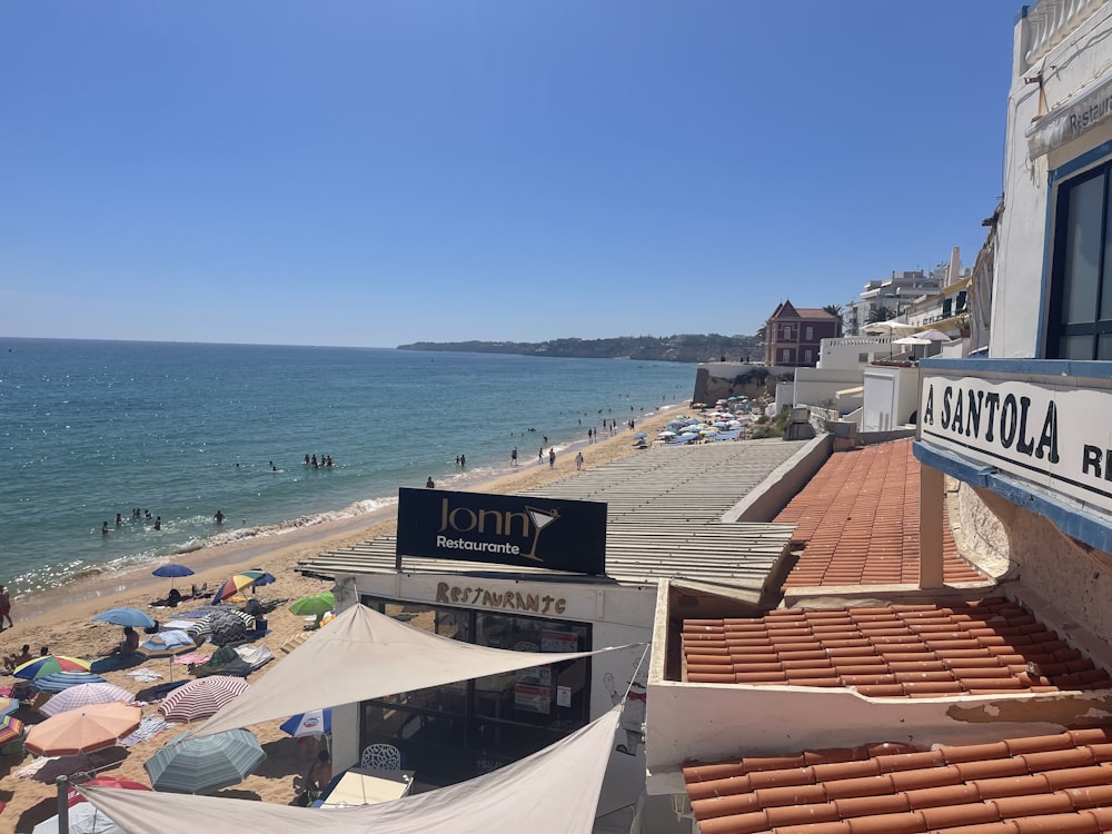 a beach with a lot of people and umbrellas