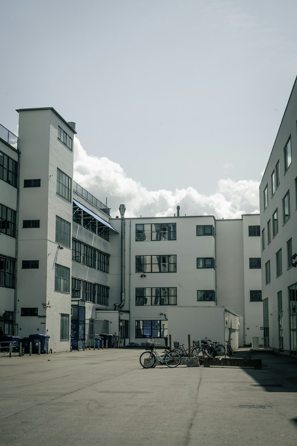 a building with a lot of windows and bicycles parked in front of it