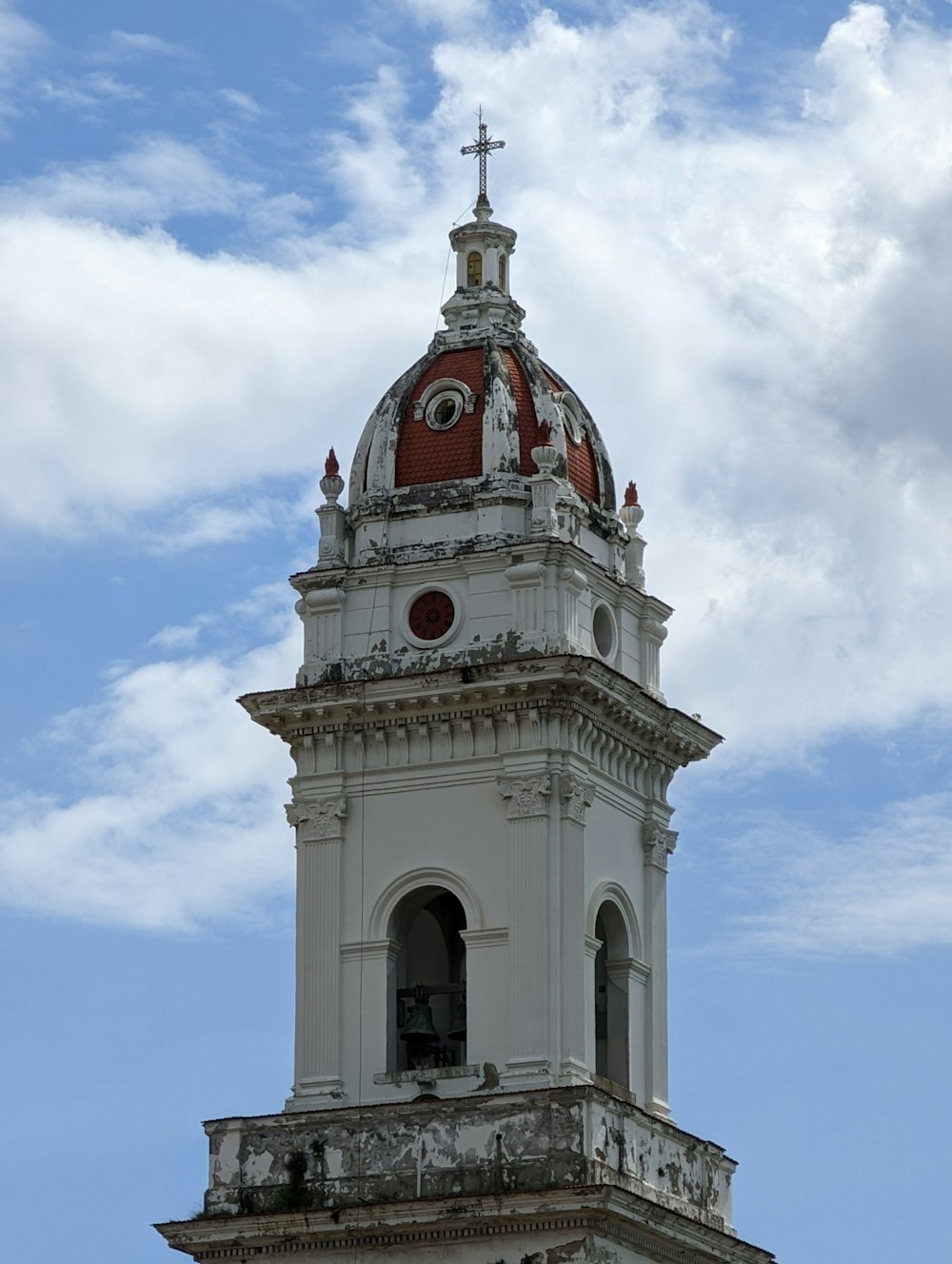 a large white clock tower with a red dome