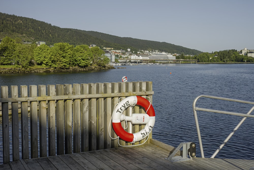 a red and white life preserver on a wooden dock