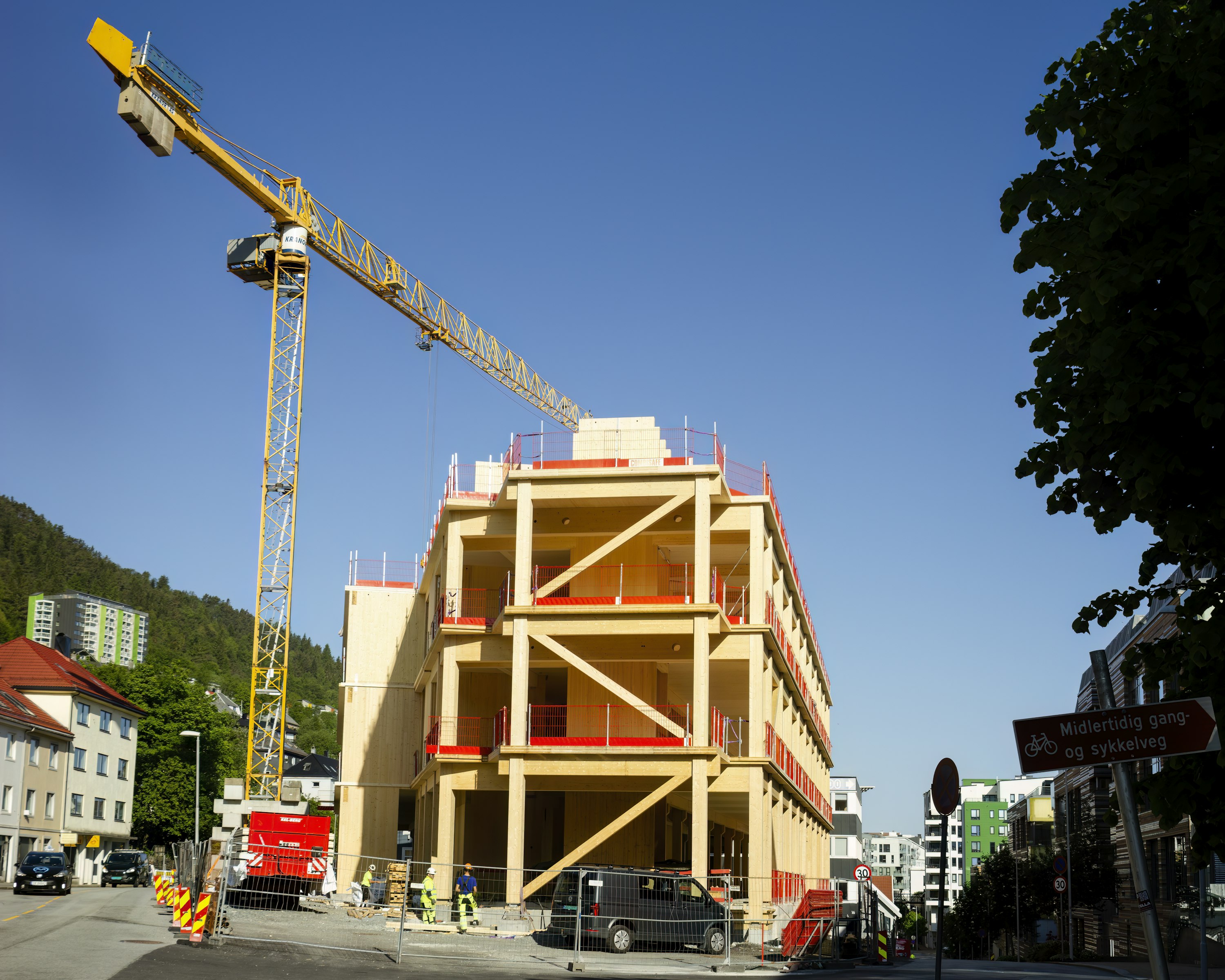 Crane on top of a building under construction steel frame