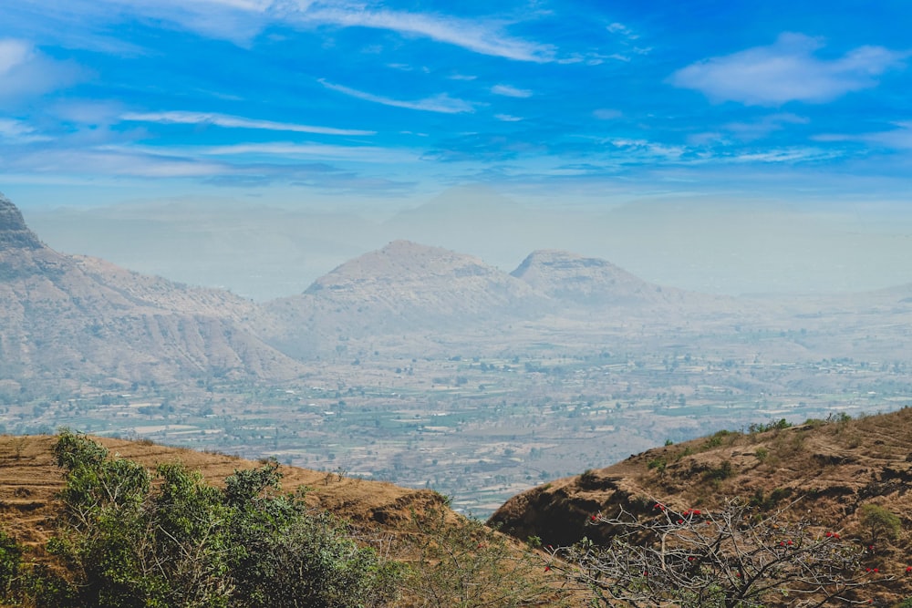 a view of a mountain range with a blue sky in the background