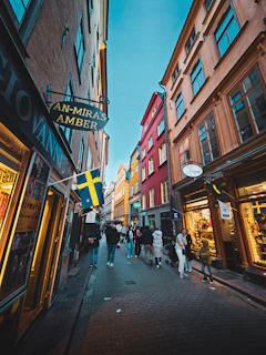 A vibrant street scene in a Swedish town with colorful buildings and cobblestone streets